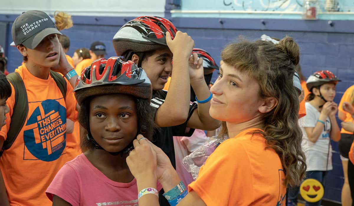 Making sure the helmets fits correctly at the Freewheels Bike Camp.