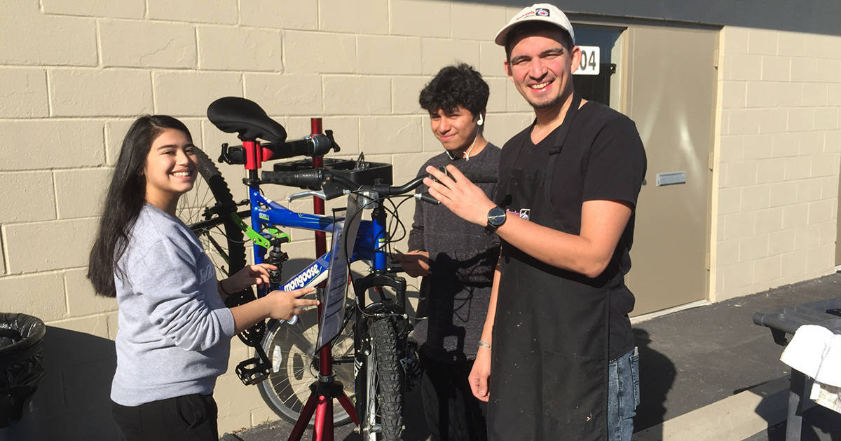 High school students learn bike repair at Freewheels Houston