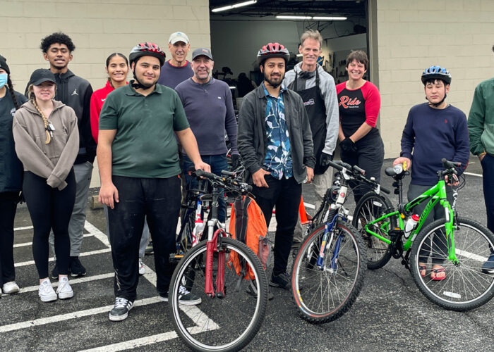 Freewheels volunteers with Afghan refugees receiving bikes