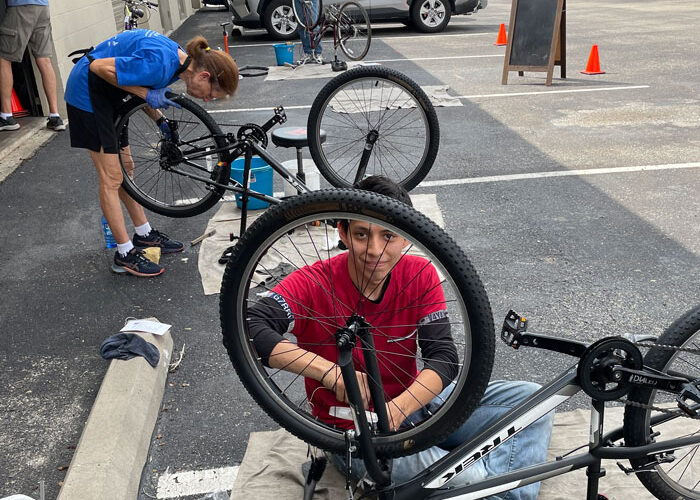 Freewheels volunteer bike mechanics repair bicycles for distribution