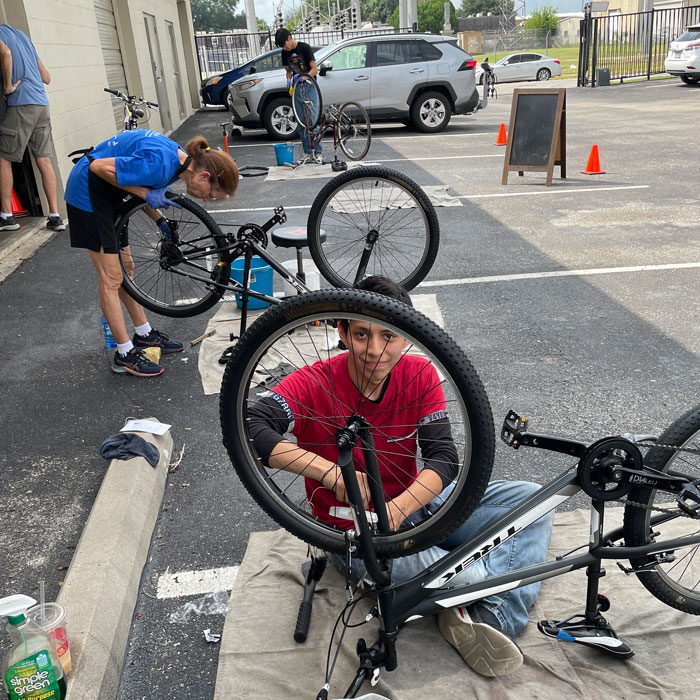 Freewheels volunteer bike mechanics repair bicycles for distribution