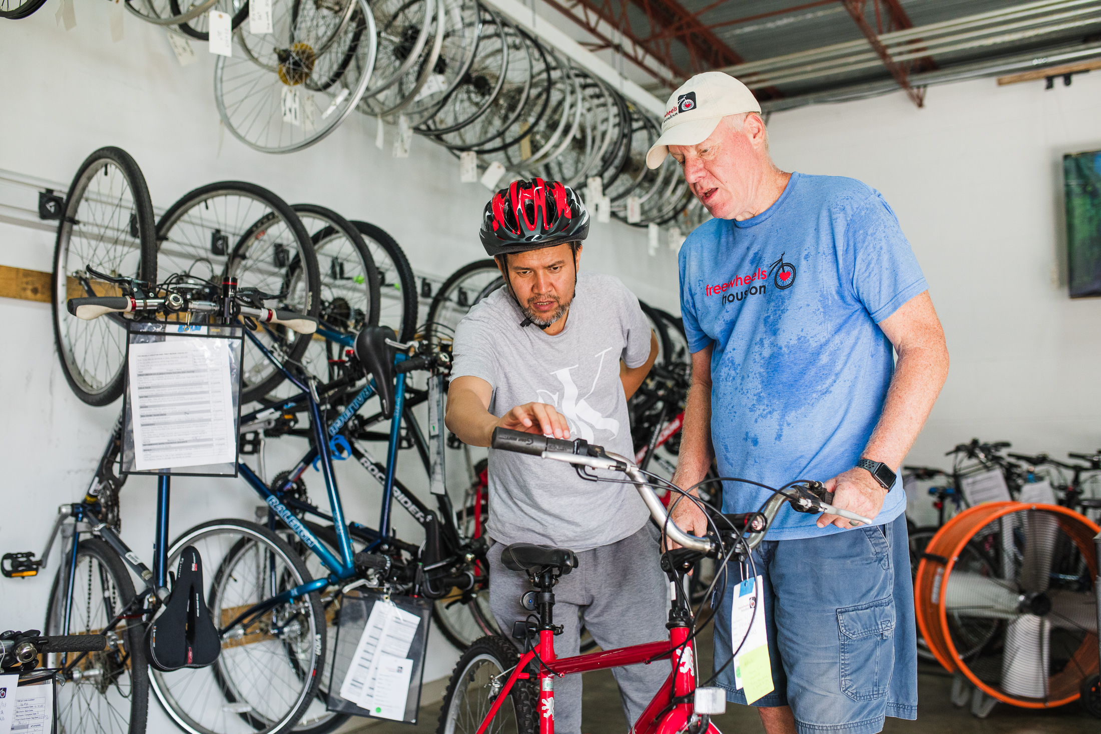 Freewheels volunteer with refugee receiving a refurbished bike